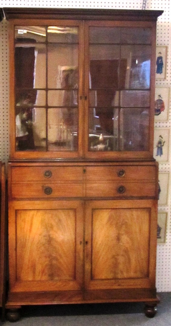 Appraisal: A George III oak bookcase secretaire cupboard on turned feet