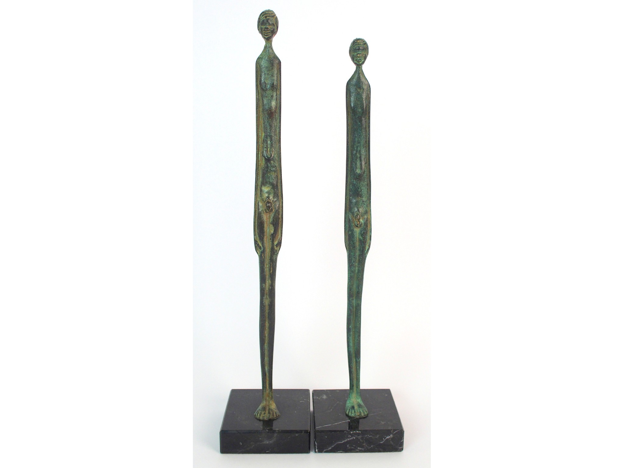 Appraisal: A pair of bronze figural sculpturesthe tall slim sculptures formed