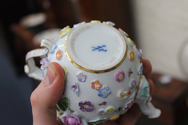 Appraisal: A CONTINENTAL PORCELAIN FLOWER ENCRUSTED SMALL SIZE TEAPOT with mask