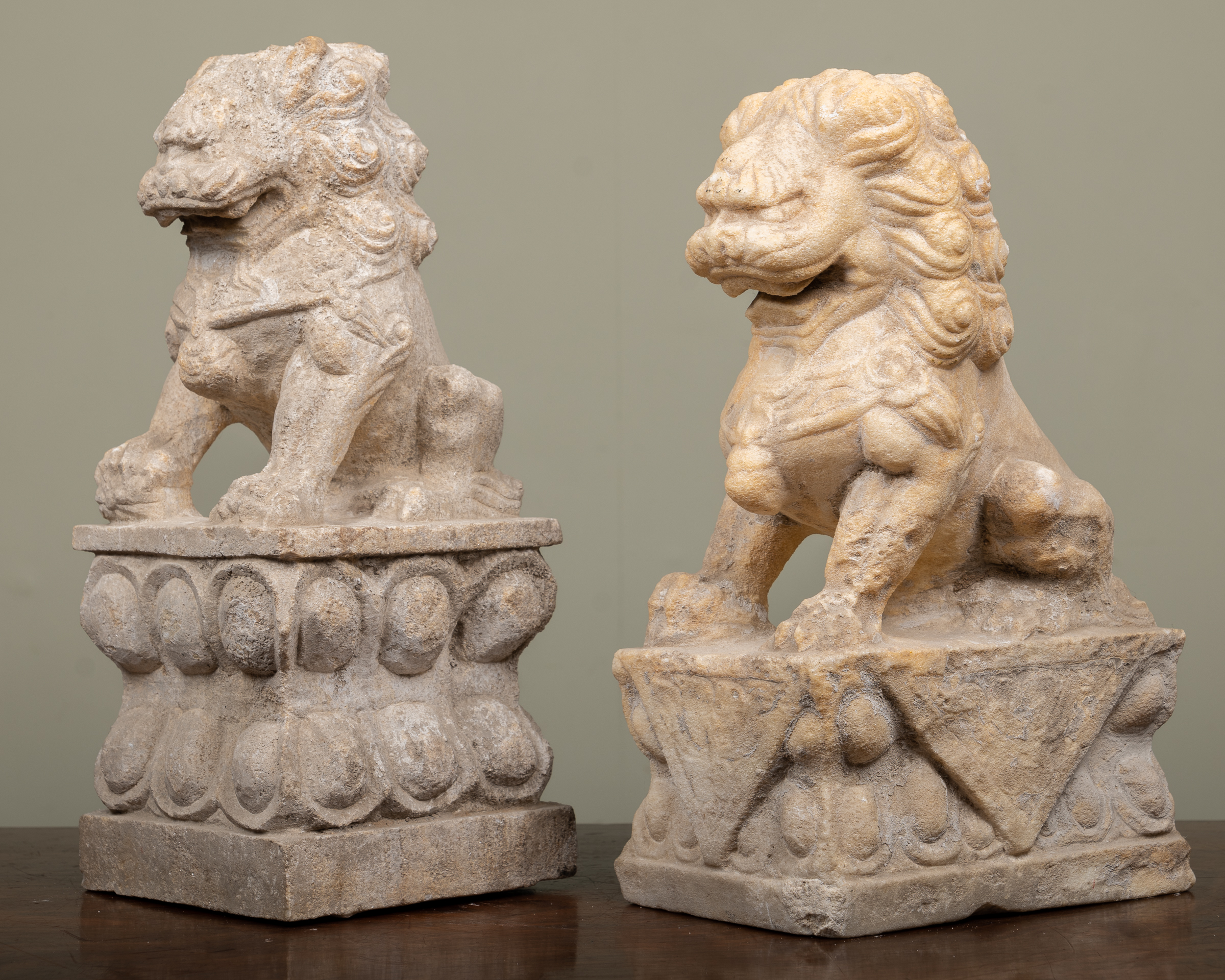 Appraisal: Two similar carved stone dogs of foe on decorative plinth