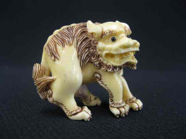 Appraisal: Carved Ivory Netsuke of a Foo Dog onyx eyes ''