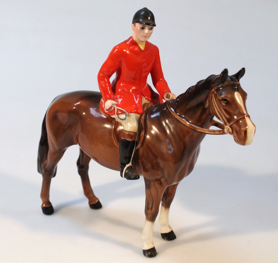 Appraisal: A Beswick model of a huntsman seated on a chestnut