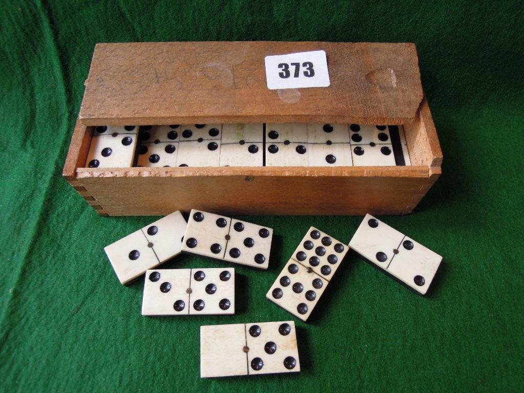 Appraisal: A set of four bone and ebony dominoes in a