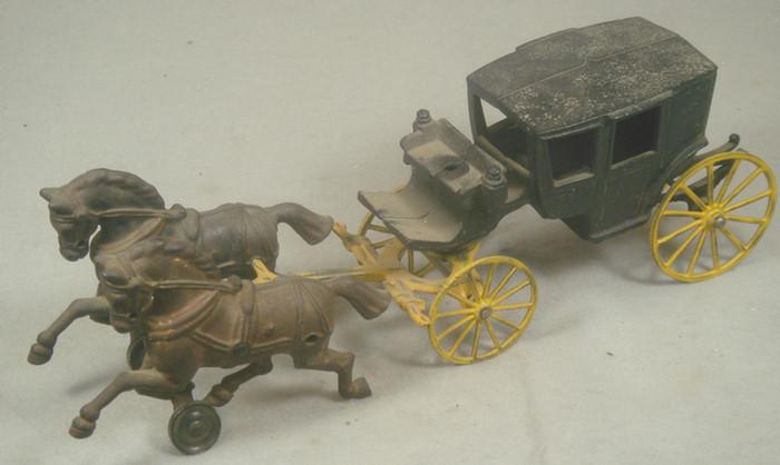 Appraisal: Cast iron toy horse drawn covered carriage with yellow axles