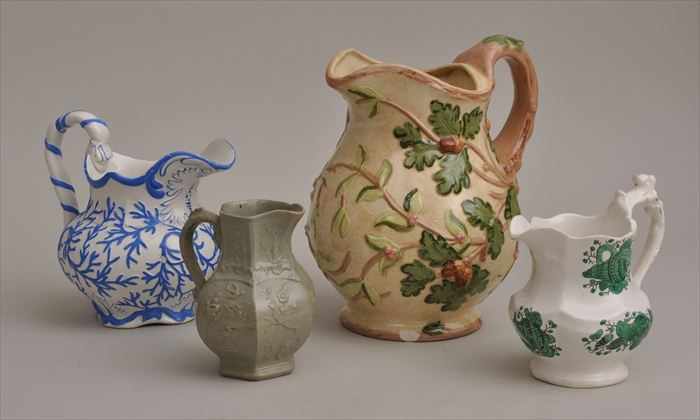 Appraisal: THREE STAFFORDSHIRE IRONSTONE MILK JUGS One marked Mason's Patent Ironstone