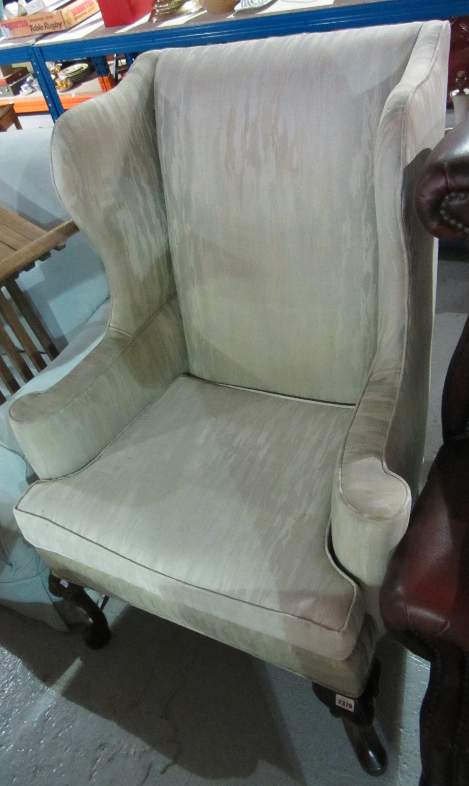 Appraisal: A mahogany framed wingback armchair with cabriole supports