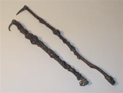 Appraisal: Two unusual lacquered rootwood iron mounted picks th century