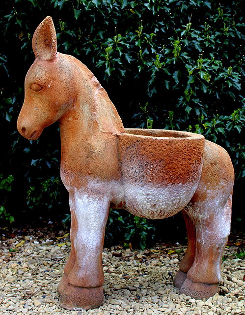 Appraisal: A CAST COMPOSITE PLANTER in the form of a donkey