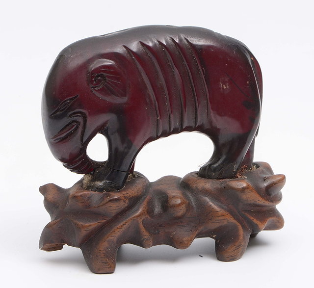 Appraisal: A Chinese small carved amber elephant th th Centuryon a