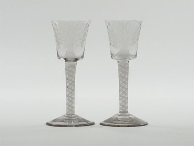 Appraisal: A pair of wine glasses the bucket-shaped bowls each engraved