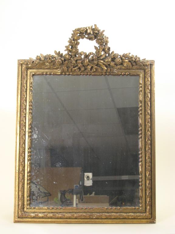 Appraisal: A gilt framed Mirror with finely carved floral ribbon surmount