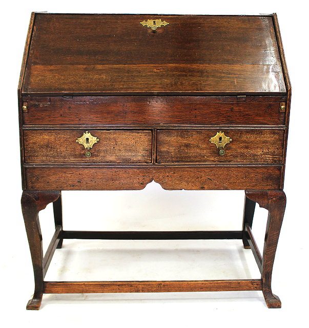 Appraisal: AN TH CENTURY COUNTRY OAK BUREAU the sloped fall front