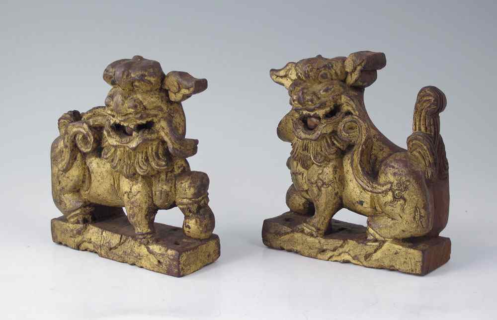 Appraisal: PAIR CARVED WOOD FOO DOGS Gilt front red stained verso