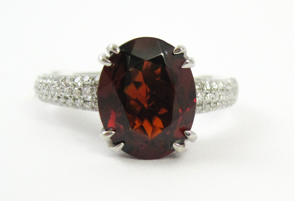 Appraisal: GARNET DIAMOND AND FOURTEEN KARAT GOLD RING The white gold