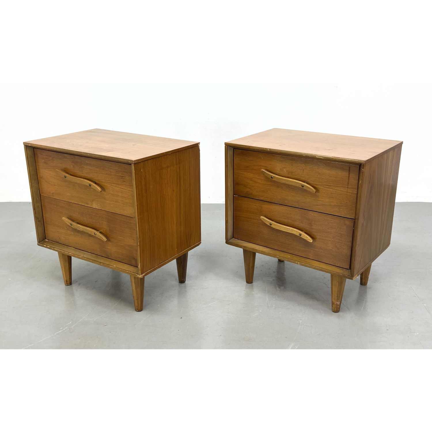 Appraisal: Pair of Unagusta walnut nightstands side tables Sculptural pulls Dimensions