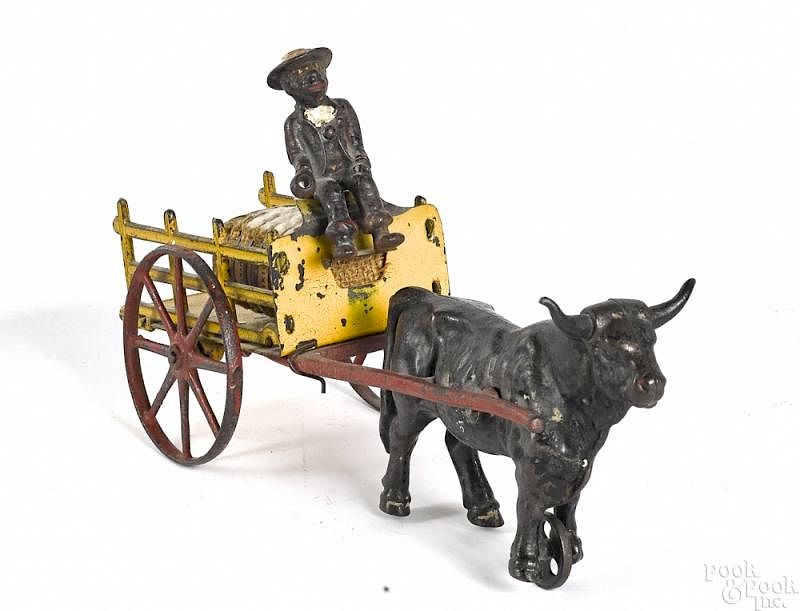 Appraisal: Kenton cast iron oxen drawn farm cart Kenton cast iron