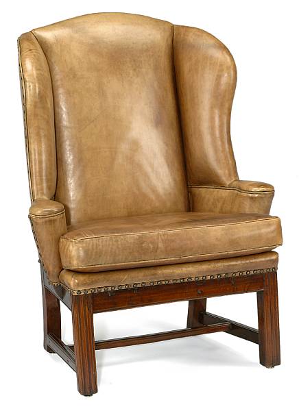 Appraisal: A George III style fruitwood and leather upholstered wing chair