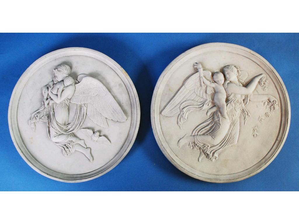 Appraisal: PAIR OF MOULDED WHITE PLASTER CIRCULAR WALL PLAQUES depicting angels