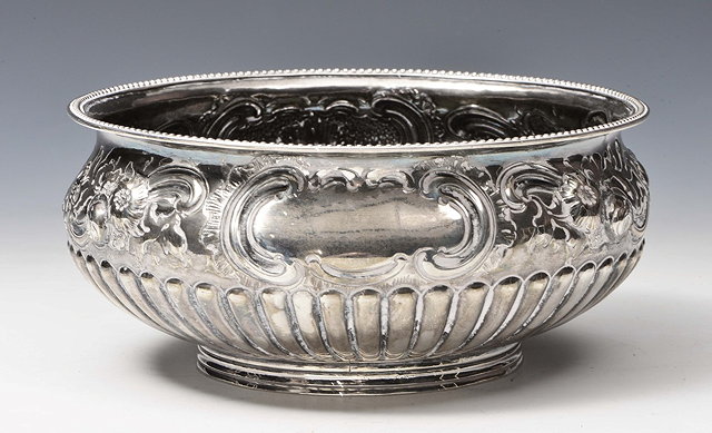 Appraisal: A GEORGE III SILVER BOWL with reeded lower body chased