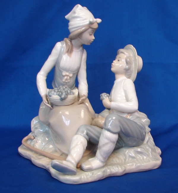 Appraisal: Nao by Lladro - Boy and Girl Eating Grapes Good