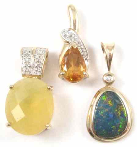 Appraisal: THREE FOURTEEN KARAT GOLD PENDANTS one set with an oval