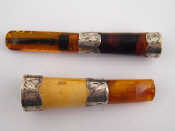 Appraisal: A matching cigarette holder and cheroot holder in amber and