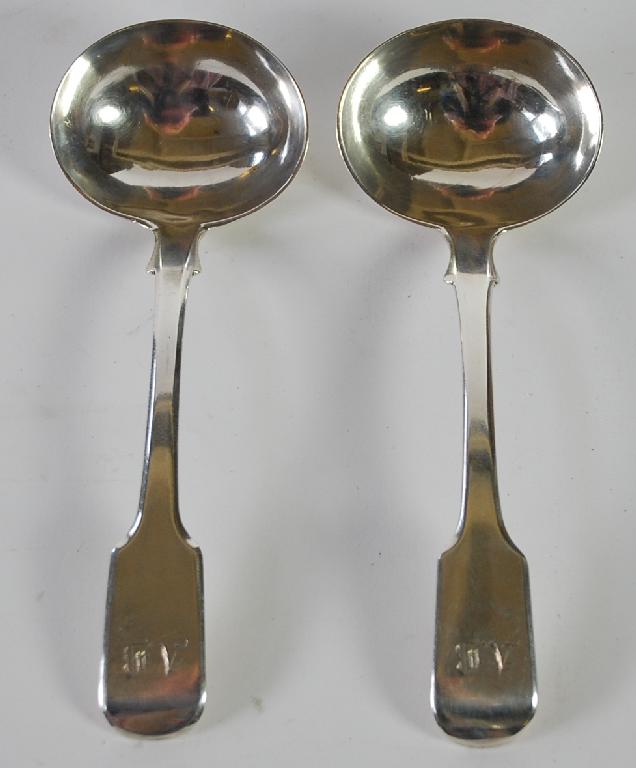 Appraisal: PAIR OF GEORGE III FIDDLE PATTERN SILVER SAUCE LADLES initialled