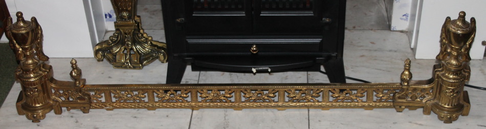 Appraisal: A late thC gilt brass fender with urn finials and