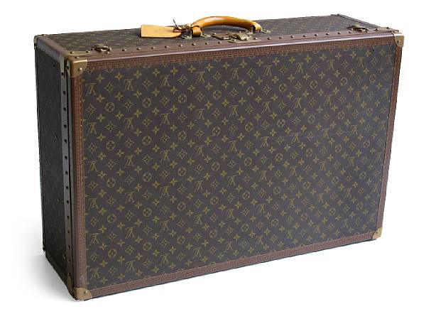 Appraisal: A Louis Vuitton suitcase The rectangular case covered in monograms