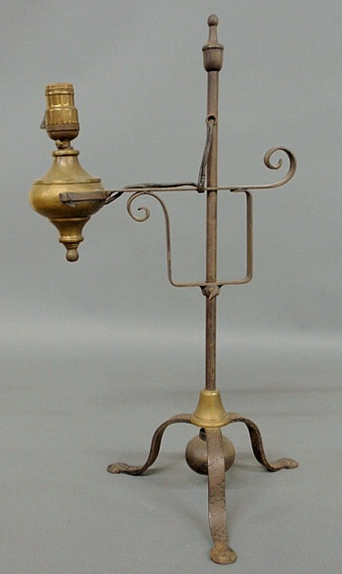 Appraisal: Wrought iron and brass adjustable table lamp with penny feet