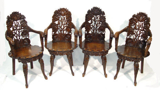 Appraisal: Set of four Victorian fruitwood open armchairs profusely carved with