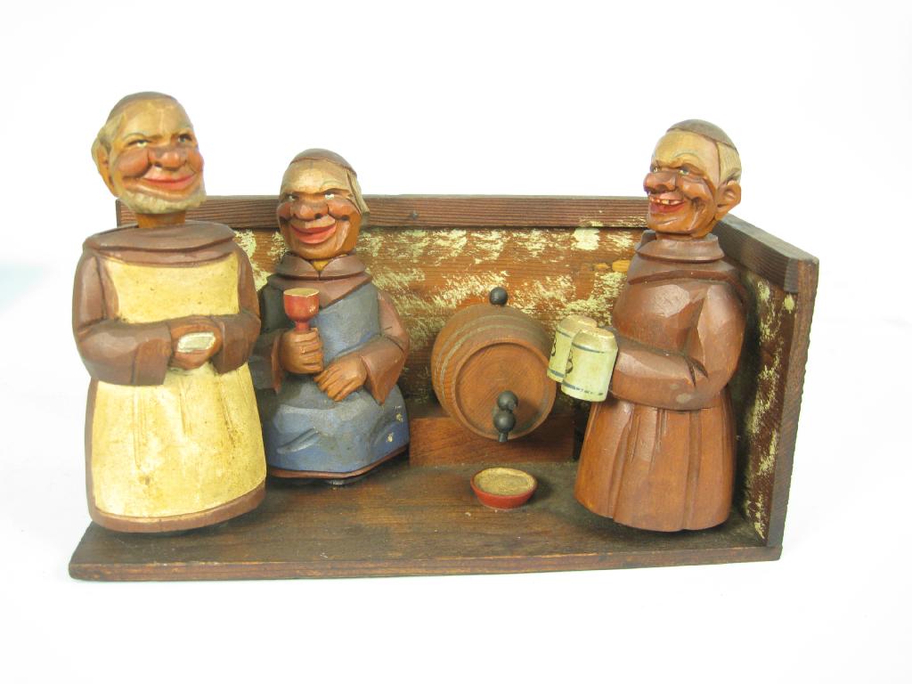 Appraisal: A Tyrolean carved wood Bar Set depicting three monks and