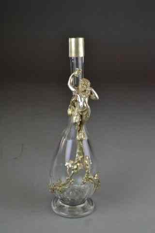 Appraisal: BACCHUS FIGURAL GLASS AND SILVER DECANTERPolished cut faceted glass decanter