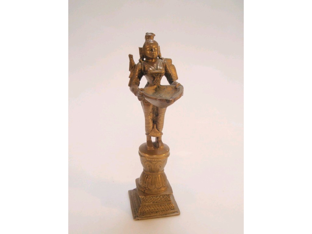 Appraisal: A thC Indian brass lamp modelled as an Hindu god