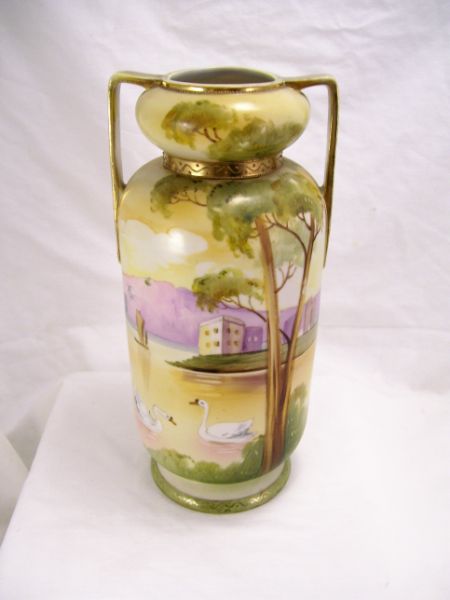 Appraisal: Nippon Porcelain Vase Double strap handles gold decoration Hand painted