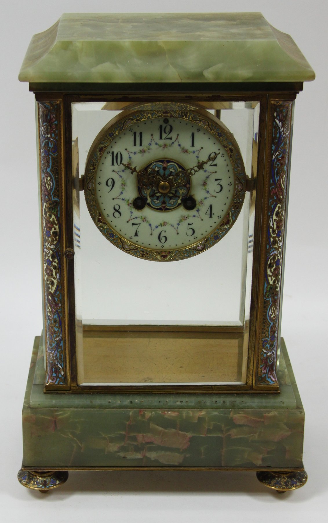 Appraisal: An onyx and champleve enamel cased mantel clock the circular