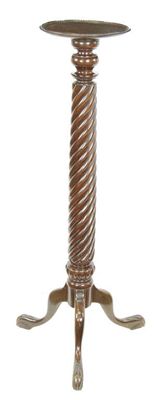 Appraisal: A mahogany torchere with a spiral twist stem on tripod