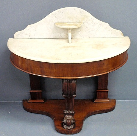 Appraisal: Unusual mahogany demilune console table c with a marble top