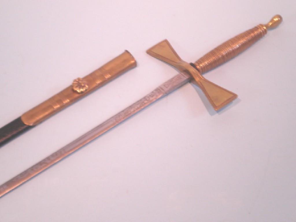 Appraisal: A ceremonial sword with a leather scabbard brass handle the