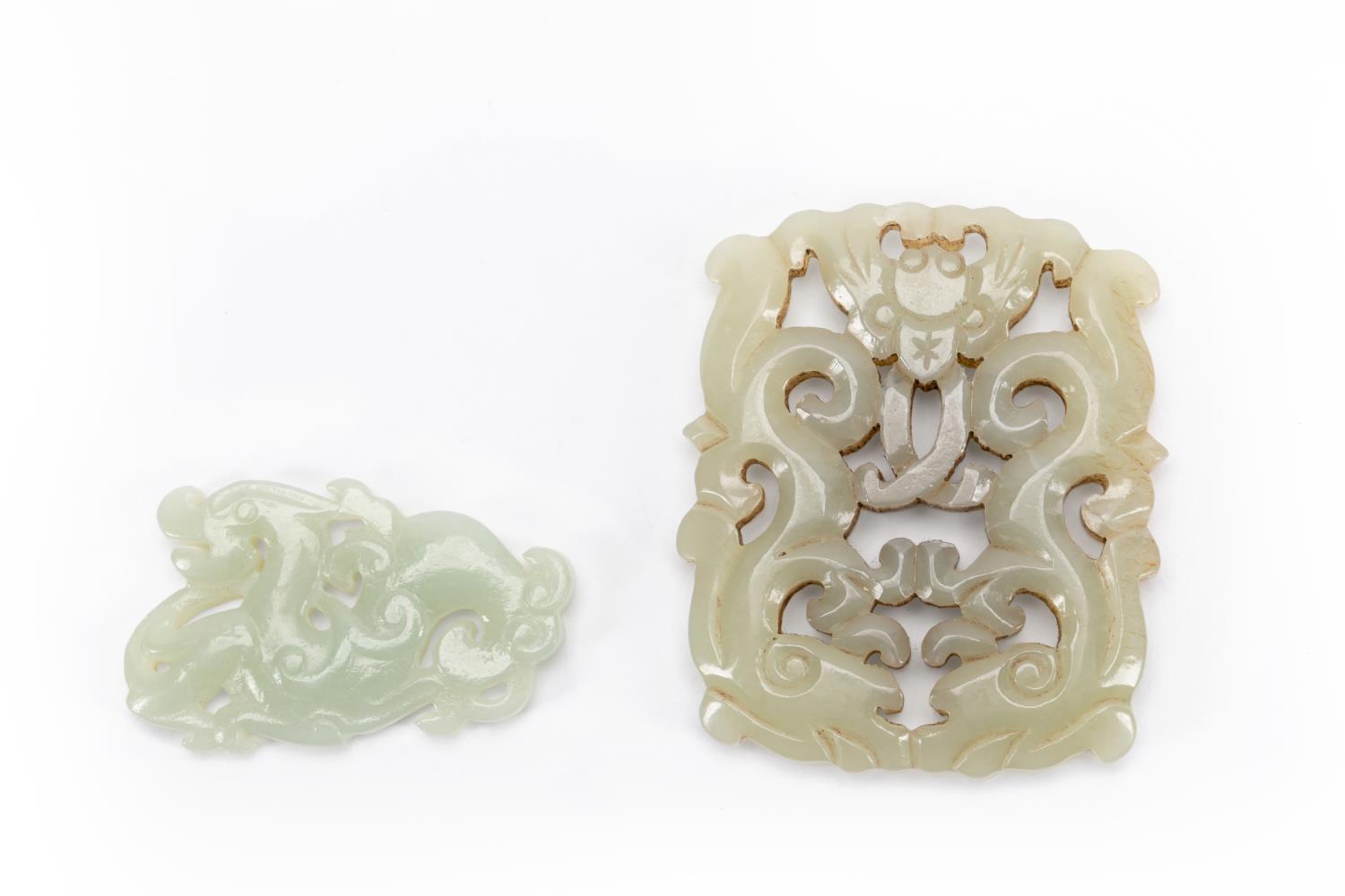 Appraisal: TWO CHINESE CARVED CELADON JADE DRAGON PENDANTS Two Chinese carved