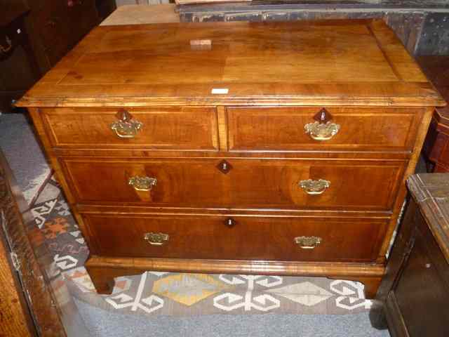 Appraisal: A GEORGIAN WALNUT CHEST of two long two short drawers