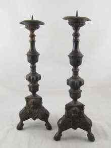 Appraisal: A pair of bronze pricket candlesticks the triangular bases with