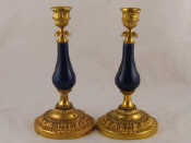 Appraisal: A pair of gilt brass candlesticks with blue ceramic baluster