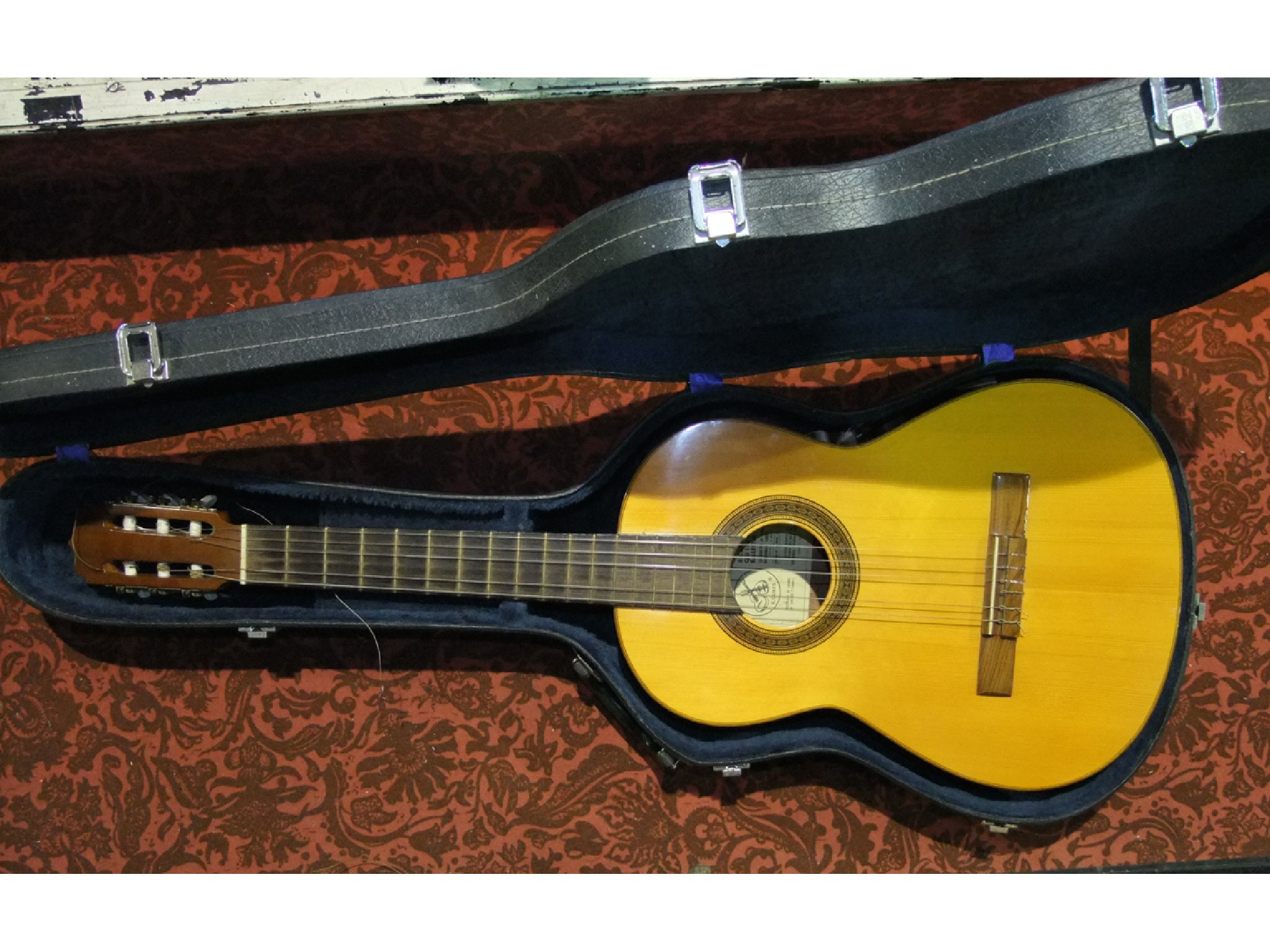 Appraisal: A cased acoustic guitar with label to sound hole interior