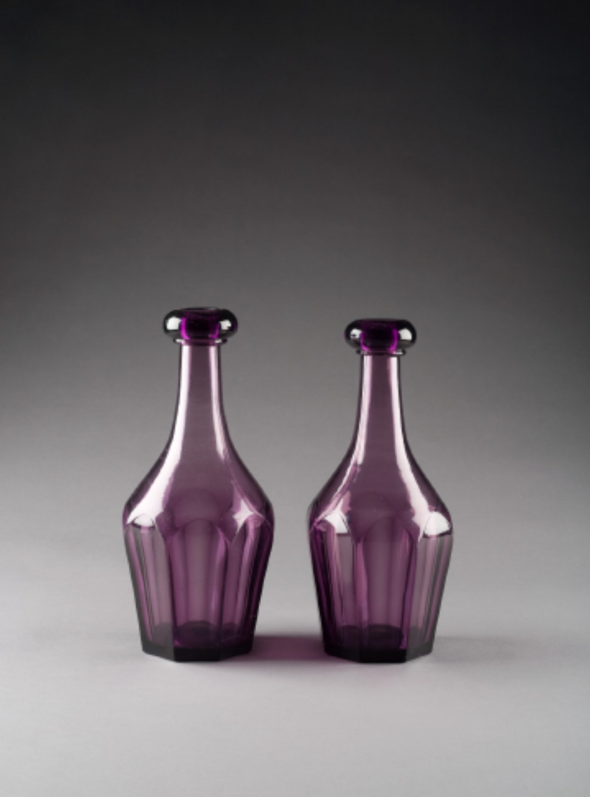 Appraisal: PAIR OF AMERICAN BLOWN-MOLDED AMETHYST GLASS BAR DECANTERS BOSTON SANDWICH