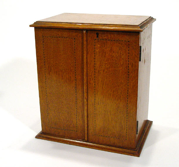 Appraisal: Edwardian inlaid oak cabinet fitted two doors enclosing three shelves