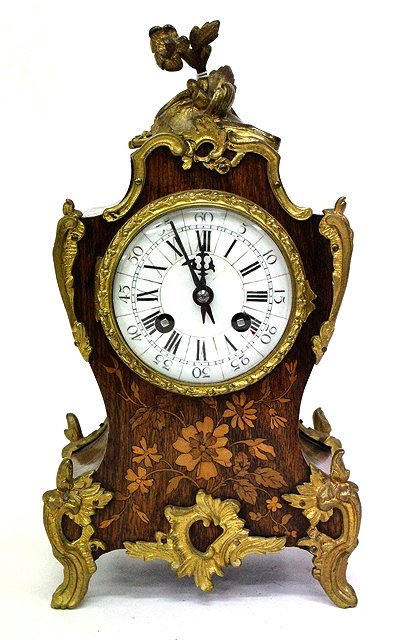 Appraisal: A FRENCH ROSEWOOD CASED MANTLE CLOCK with cast gilt metal