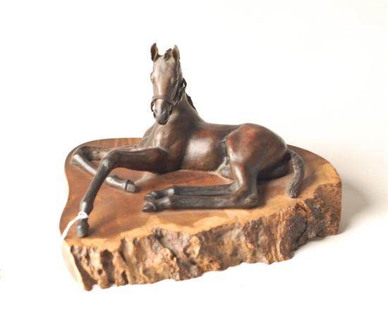 Appraisal: Bronze Reclining Horse on wooden stand high long