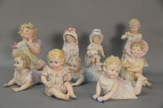 Appraisal: Group of nine porcelain and bisque baby and child figures