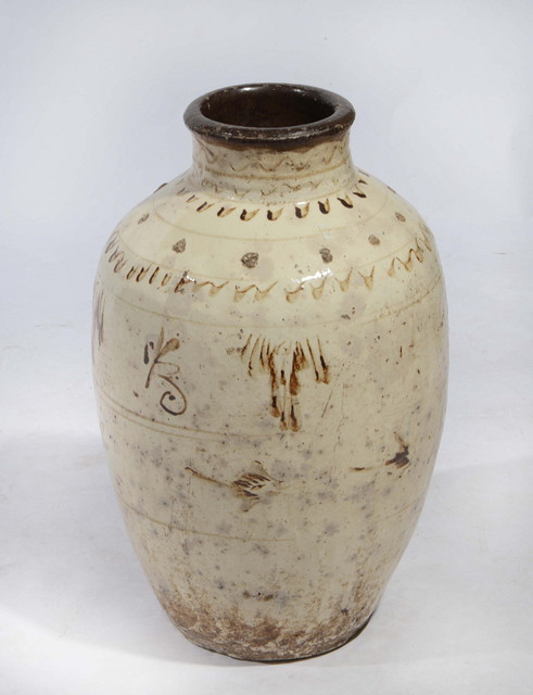 Appraisal: A CHINESE CIZHOU-STYLE STORAGE JAR with cream glaze and brown